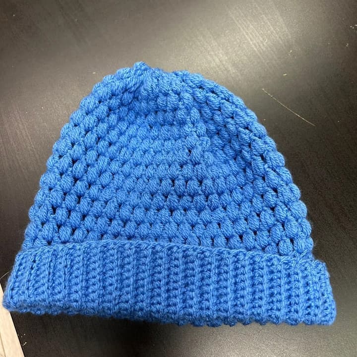 A blue hat crocheted by our volunteers