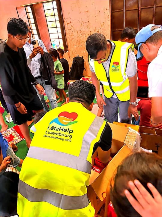 Volunteers opening and handing out relief parcels